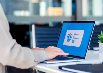 A person typing on a laptop.