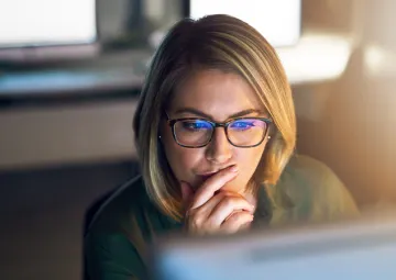 A woman looking at a computer screen.