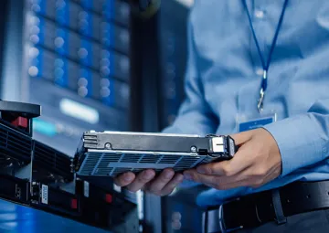 A person holding a server component.
