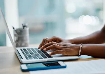 A person typing on a laptop.